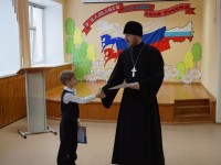 Отец Григорий награждает одного из победителей